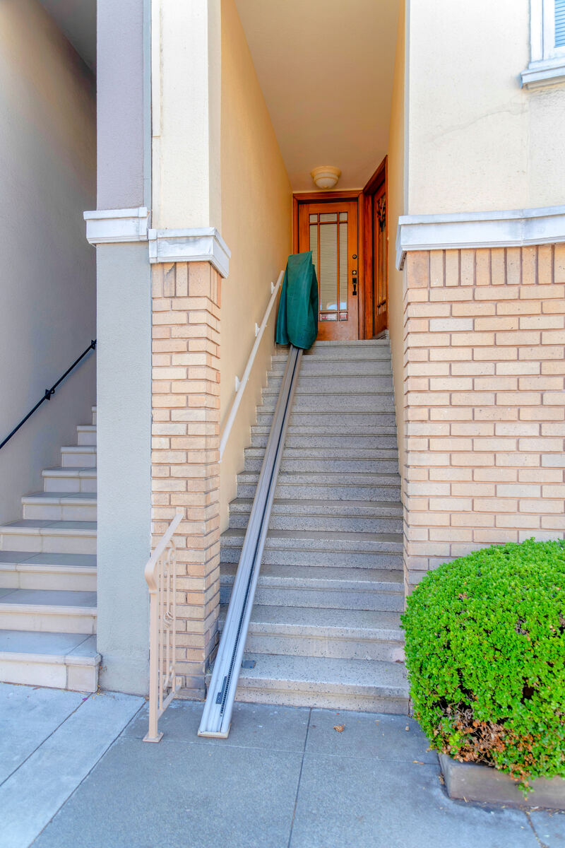 Outdoor stairlift on steps outside a house