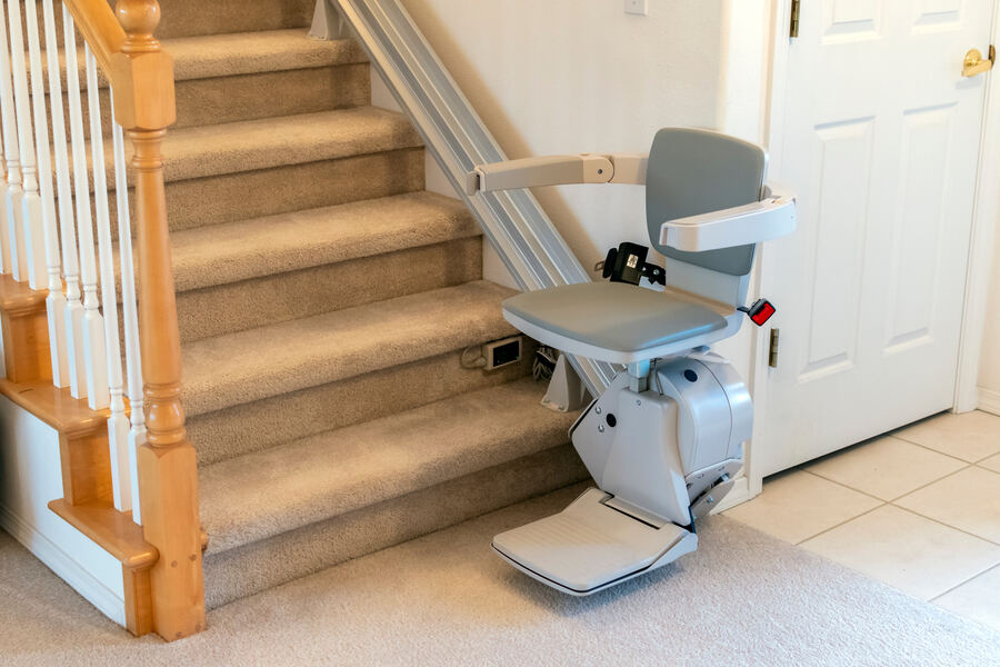 A stairlift on a carpeted staircase in a British home